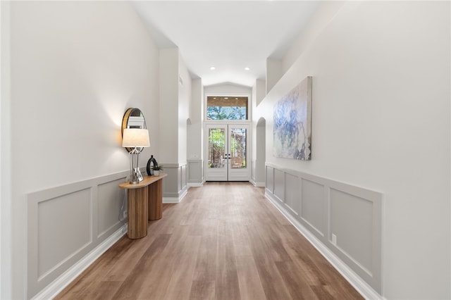38027 Cherrywood Dr, Murrieta, CA 92562 - foyer entrance featuring lofted ceiling, a decorative wall, wood finished floors, wainscoting, and french doors