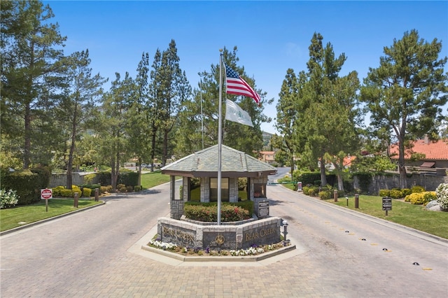 38027 Cherrywood Dr, Murrieta, CA 92562 - view of decorative road featuring curbs, a gated entry, and traffic signs