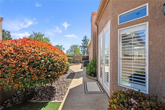exterior space featuring fence and stucco siding