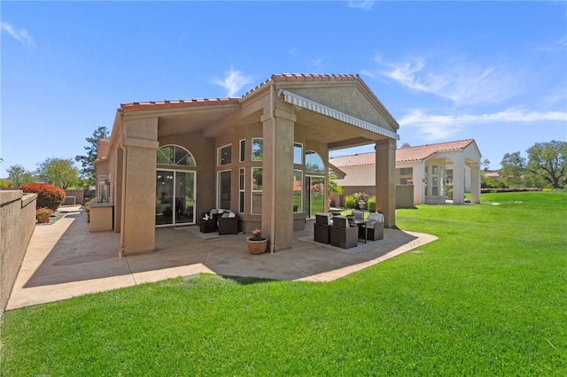 back of house with a tile roof, a patio area, a yard, stucco siding, and an outdoor living space
