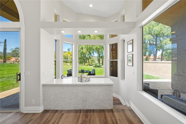bathroom with baseboards, wood finished floors, and recessed lighting