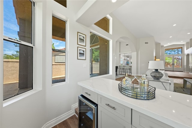 38027 Cherrywood Dr, Murrieta, CA 92562 - bar with beverage cooler, dark wood-style floors, arched walkways, and recessed lighting