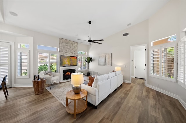 38027 Cherrywood Dr, Murrieta, CA 92562 - living room featuring a stone fireplace, ceiling fan, wood finished floors, and high vaulted ceiling