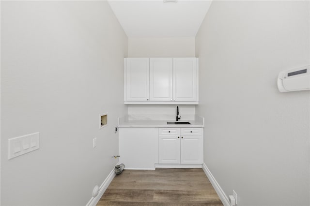 38027 Cherrywood Dr, Murrieta, CA 92562 - laundry area featuring washer hookup, light wood-style flooring, gas dryer hookup, cabinet space, and bar area