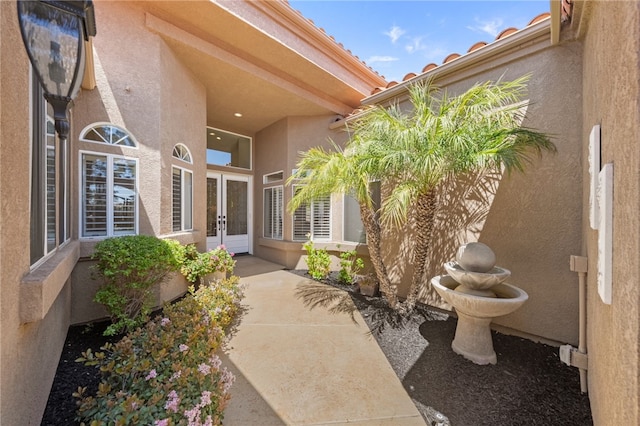 entrance to property with french doors and stucco siding