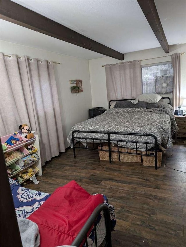 bedroom with wood finished floors and beam ceiling
