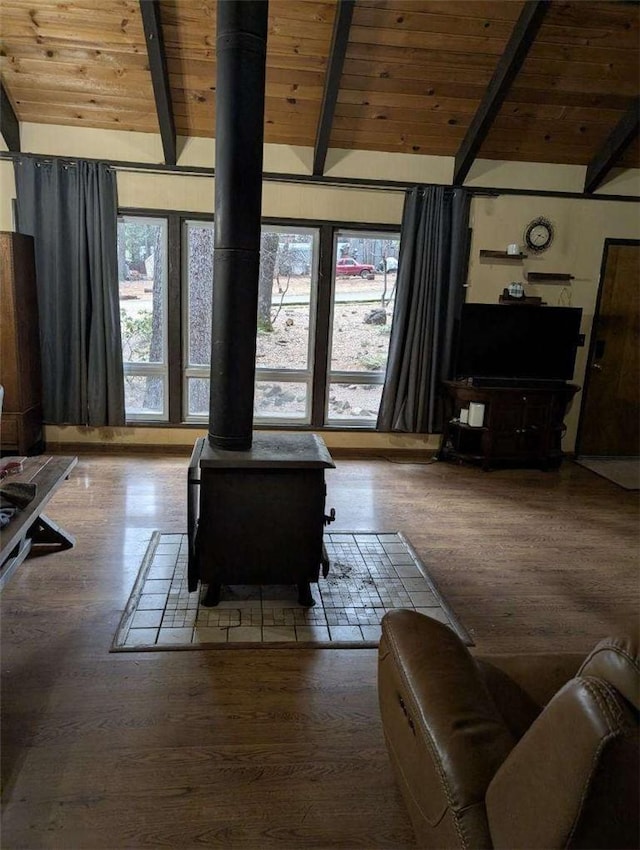 living room with a healthy amount of sunlight, wood ceiling, and lofted ceiling with beams