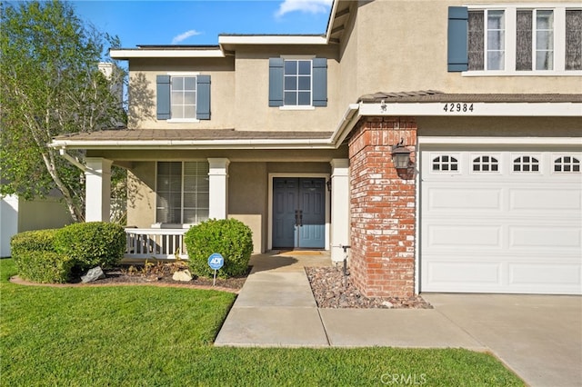 42984 Calle Reva, Temecula, CA 92592 - doorway to property featuring brick siding, a porch, an attached garage, and stucco siding
