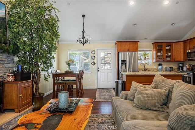 30964 Summit Dr, Running Springs, CA 92382 - living room with a chandelier, dark wood-style floors, ornamental molding, and a wealth of natural light