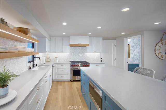 3601 Finley Ave, Newport Beach, CA 92663 - kitchen featuring white cabinets, a sink, light countertops, stainless steel stove, and blue cabinetry