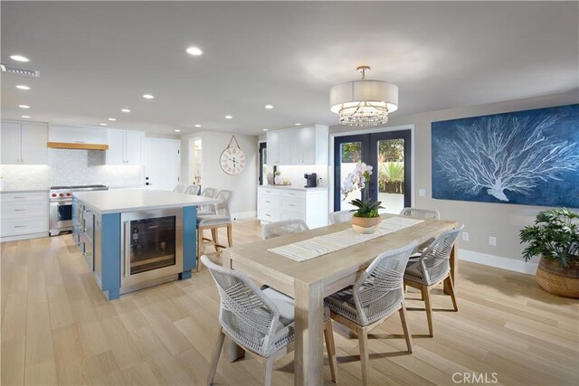 3601 Finley Ave, Newport Beach, CA 92663 - dining space with wine cooler, light wood finished floors, a chandelier, and recessed lighting