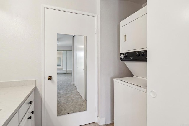 17607 Pomerado Rd Unit 204, San Diego, CA 92128 - clothes washing area with light colored carpet, cabinet space, and stacked washing maching and dryer