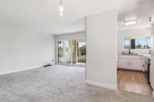 17607 Pomerado Rd Unit 204, San Diego, CA 92128 - interior space with baseboards, light colored carpet, and a sink