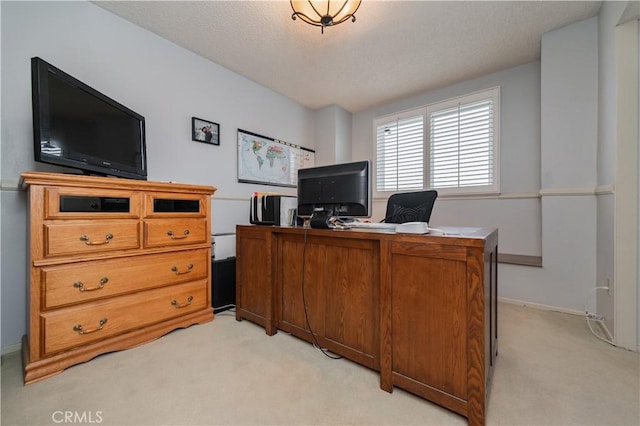 office area featuring a textured ceiling, light colored carpet, and baseboards
