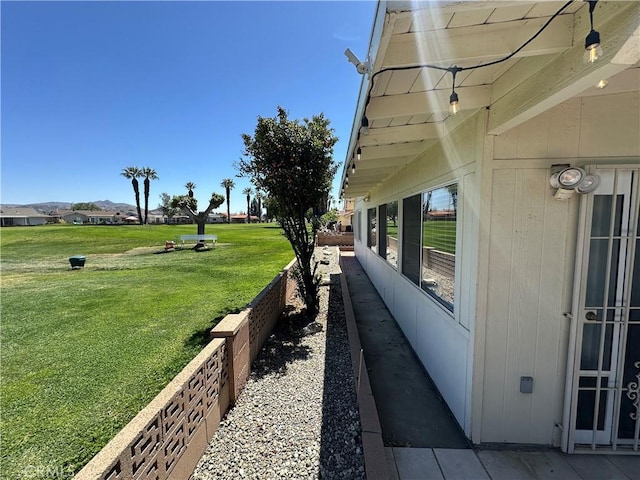 view of side of home with a yard