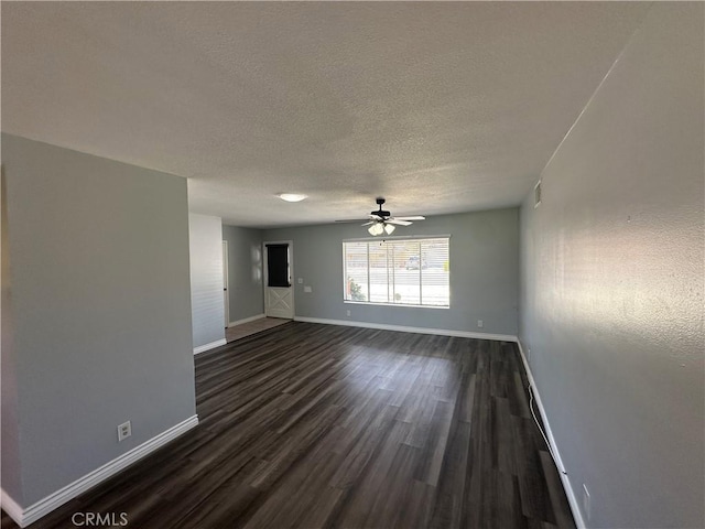 interior space with ceiling fan, a textured ceiling, baseboards, and dark wood finished floors