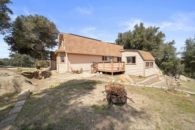 7531 Lookout Loop, Pine Valley, CA 91962 - back of property featuring a gambrel roof, a wooden deck, an outdoor fire pit, roof with shingles, and fence
