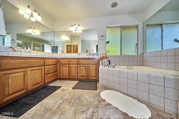 9975 Custer Ave, Lucerne Valley, CA 92356 - bathroom with double vanity, marble finish floor, and a garden tub
