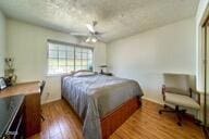9975 Custer Ave, Lucerne Valley, CA 92356 - bedroom with baseboards and wood finished floors