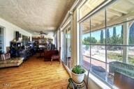 9975 Custer Ave, Lucerne Valley, CA 92356 - sunroom featuring a water view, a wealth of natural light, and wood finished floors