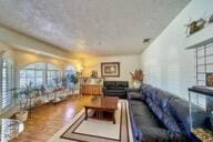 9975 Custer Ave, Lucerne Valley, CA 92356 - living area with wood finished floors and a healthy amount of sunlight
