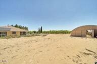 9975 Custer Ave, Lucerne Valley, CA 92356 - view of yard with a garage and a rural view