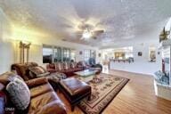 9975 Custer Ave, Lucerne Valley, CA 92356 - living room featuring plenty of natural light, a ceiling fan, and wood finished floors