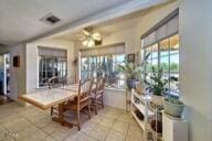 9975 Custer Ave, Lucerne Valley, CA 92356 - dining room with visible vents, ceiling fan, and tile patterned flooring