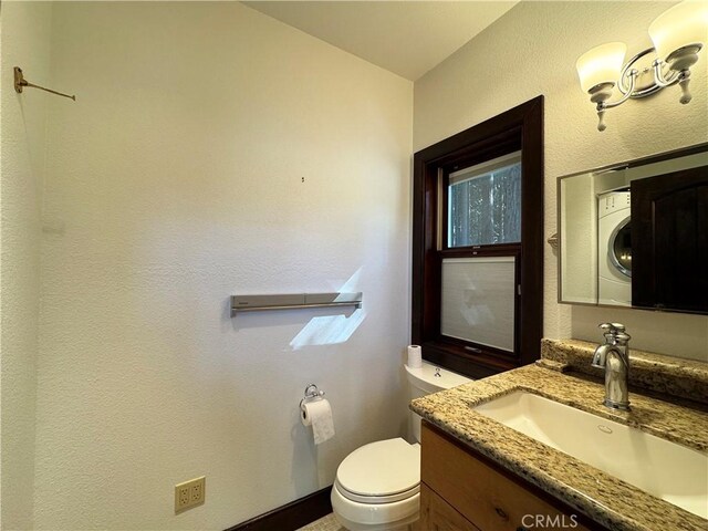 24250 Pacific Heights Dr, Westport, CA 95488 - bathroom featuring toilet, vanity, and stacked washer / drying machine