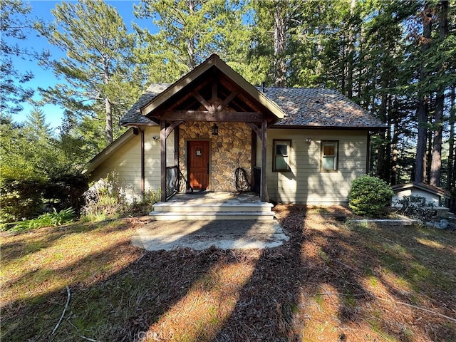 24250 Pacific Heights Dr, Westport, CA 95488 - view of front facade featuring a porch and stone siding