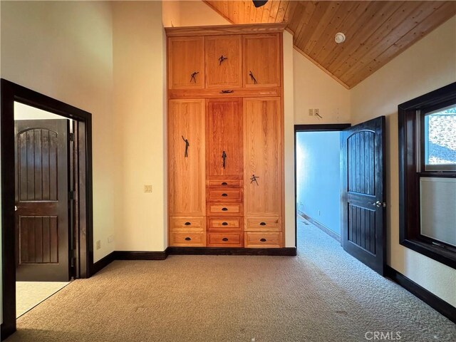 24250 Pacific Heights Dr, Westport, CA 95488 - unfurnished bedroom featuring baseboards, high vaulted ceiling, wooden ceiling, and carpet