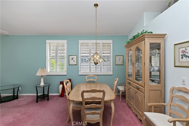 dining space with dark colored carpet, a notable chandelier, and baseboards