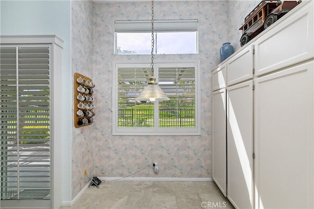 washroom featuring baseboards and wallpapered walls