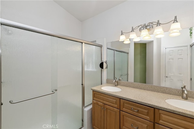 full bathroom featuring a sink, a shower stall, and double vanity