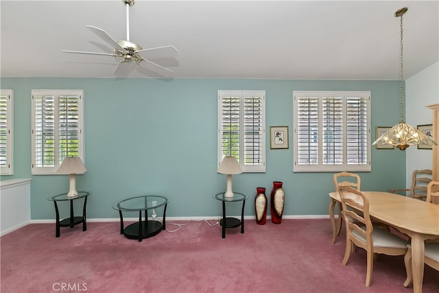 carpeted dining area featuring baseboards and ceiling fan