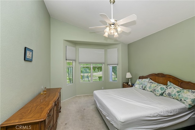 bedroom with light colored carpet, baseboards, a ceiling fan, and lofted ceiling