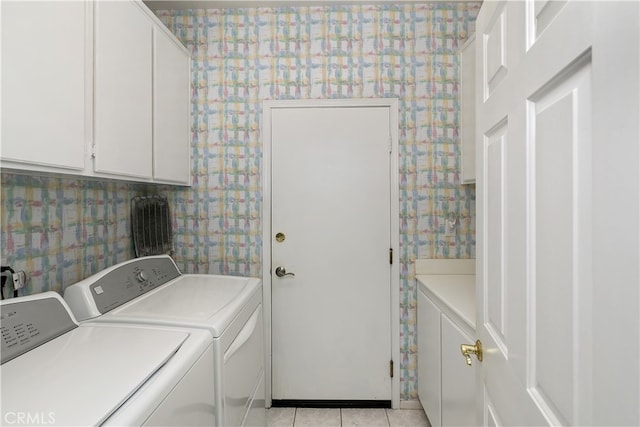 clothes washing area featuring cabinet space, washer and clothes dryer, light tile patterned flooring, and wallpapered walls