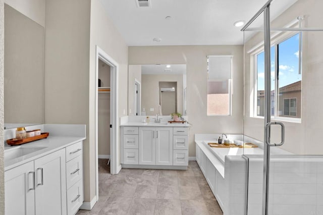 1751 Whitmore Loop, Chula Vista, CA 91913 - bathroom featuring two vanities, a bath, a stall shower, baseboards, and recessed lighting