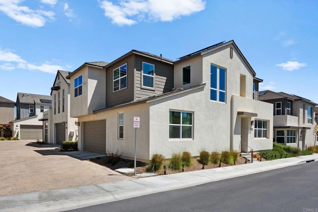 1751 Whitmore Loop, Chula Vista, CA 91913 - view of front of home with an attached garage, driveway, stucco siding, and a residential view
