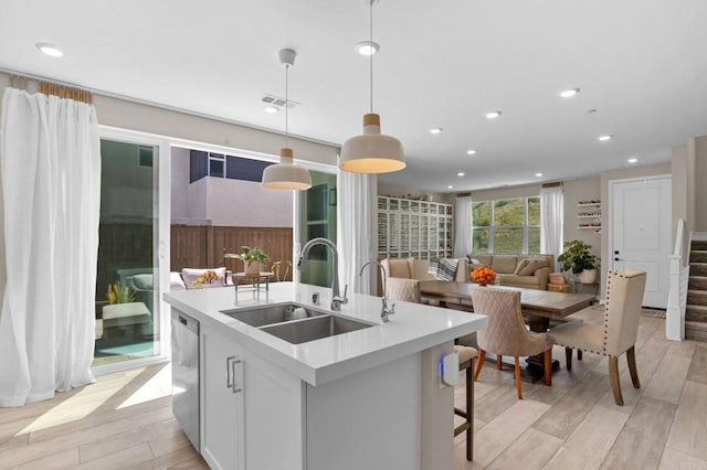 1751 Whitmore Loop, Chula Vista, CA 91913 - kitchen featuring a sink, a kitchen island with sink, light wood-style flooring, stainless steel dishwasher, and recessed lighting