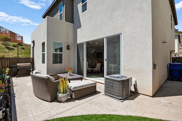 1751 Whitmore Loop, Chula Vista, CA 91913 - rear view of house featuring a patio area, stucco siding, central AC unit, fence, and an outdoor living space