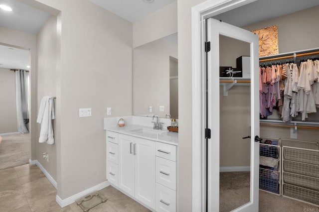 1751 Whitmore Loop, Chula Vista, CA 91913 - bathroom featuring vanity, tile patterned floors, a walk in closet, and baseboards