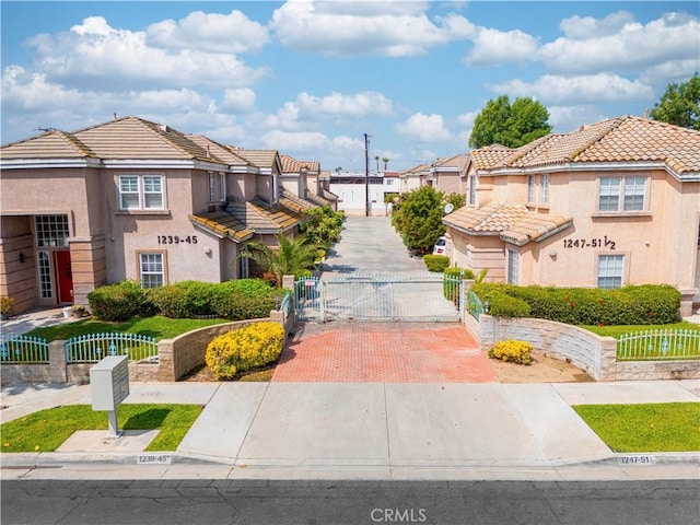 view of community featuring a fenced front yard, a residential view, and a gate