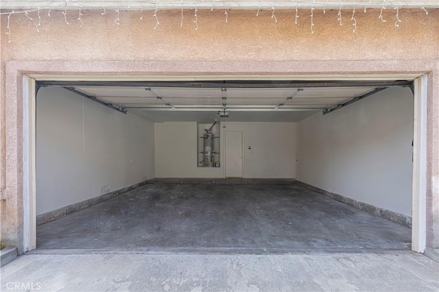 garage featuring baseboards and a garage door opener