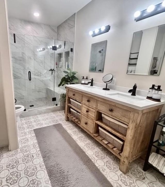 bathroom featuring a sink, toilet, a marble finish shower, tile patterned floors, and double vanity