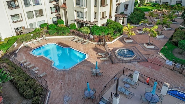 pool featuring a patio area and fence