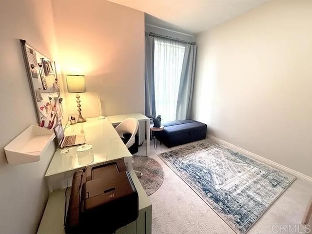 carpeted office space with baseboards