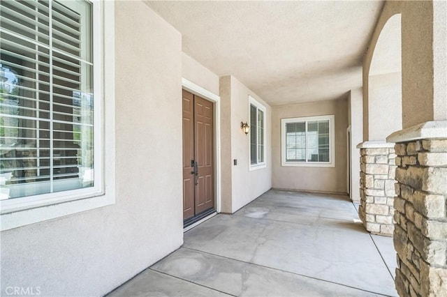 doorway to property with stucco siding
