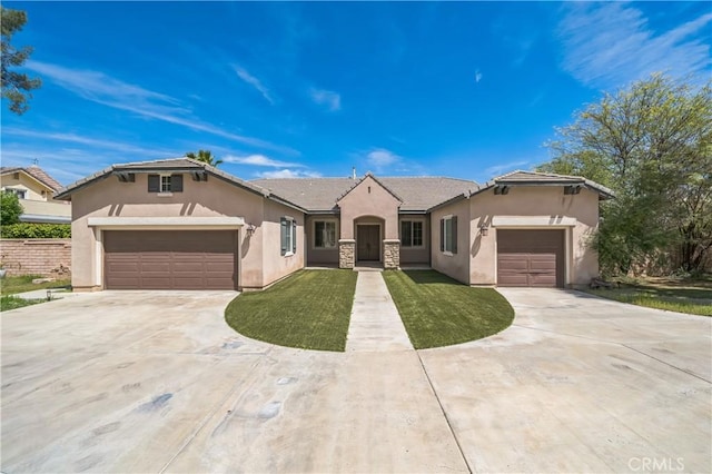 view of front of house with a tiled roof, concrete driveway, stucco siding, and a garage