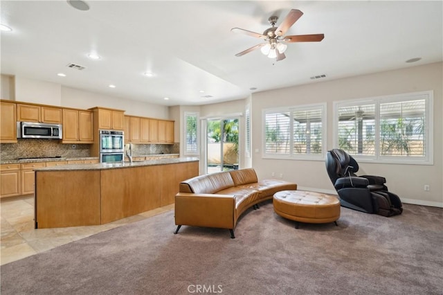 living area featuring visible vents, ceiling fan, recessed lighting, and baseboards